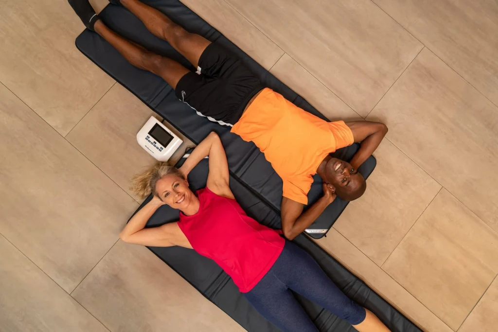Man and woman lying next to each other on their BioBalance PEMF Mats